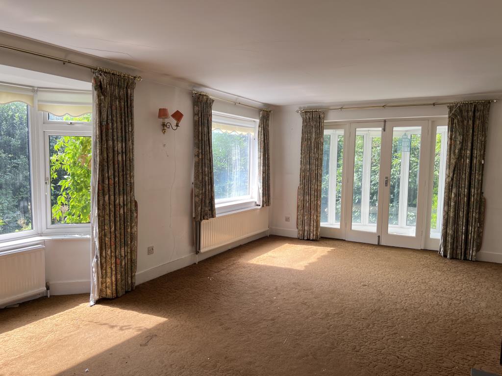 Lot: 2 - DETACHED THREE-BEDROOM HOME FOR IMPROVEMENT WITH COUNTRYSIDE VIEWS - Living room with bay window and conservatory